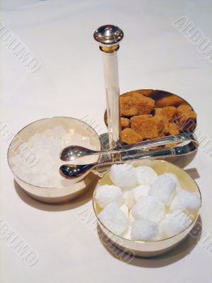 Bowls with cane sugar, white sugar and candy sugar