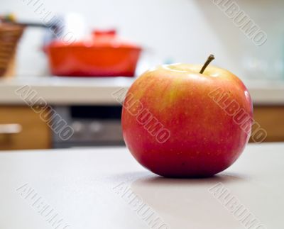 Rich apple on the kitchen desk