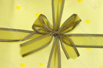 yellow ribbon with golden paper and golden hearts.