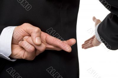 crossed fingers at handshake