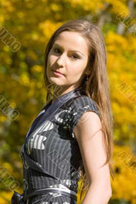The girl against autumn trees