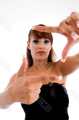 smiling glamorous female showing framing gesture