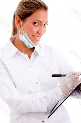 side view of smiling doctor with writing pad