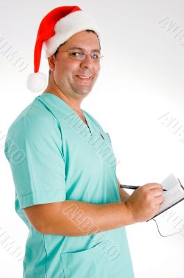 smiling surgeon writing on diary