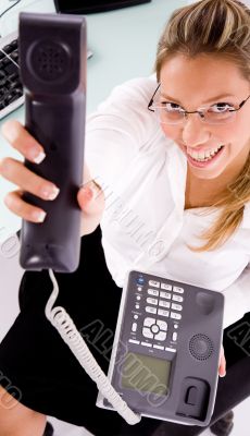 smiling employee showing phone receiver