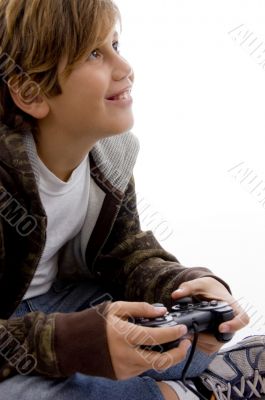 side view of glad young kid enjoying videogame
