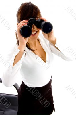 businesswoman looking through binocular