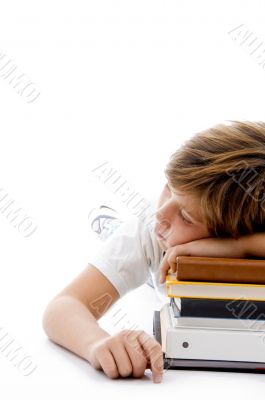 half length view of boy sleeping on books