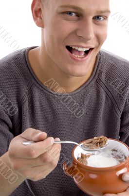 portrait of smiling male eating cornflakes portrait of smiling male eating cornflakes