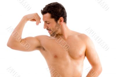 strong man looking his muscles