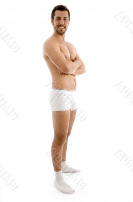 standing shirtless male with folded hands