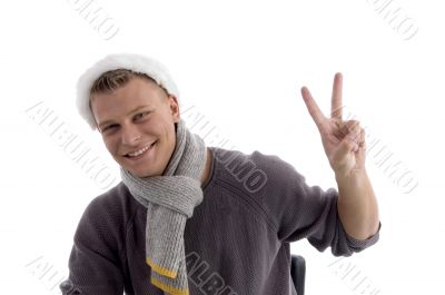 young man with christmas hat showing two fingers