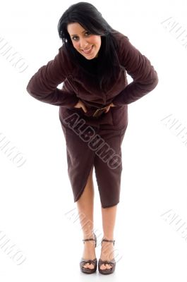 bending woman wearing overcoat on white background