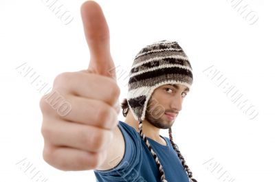 handsome guy wearing woolen cap with thumbs up