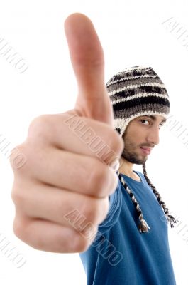 man wearing winter cap showing thumbs up