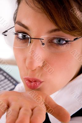 front view of female executive blowing flying kiss