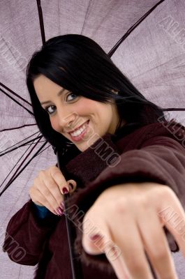 front view of pointing woman holding umbrella