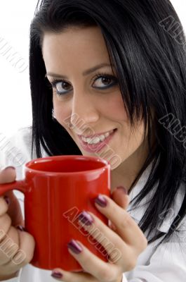 front view of smiling doctor holding mug