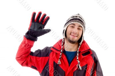 man wearing winter cap and jacket waving hello man wearing winter cap and jacket waving hello