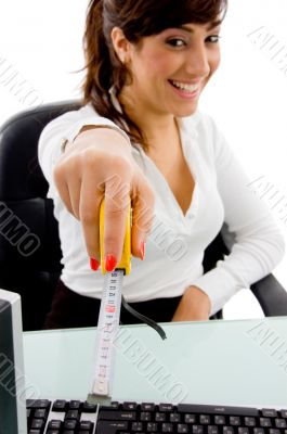 smiling woman showing measurement tape