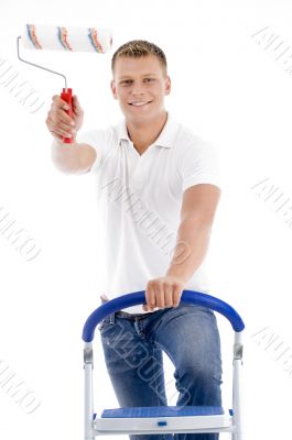 front pose of smiling male holding brush