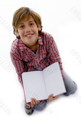 front view of boy sitting and reading book front view of boy sitting and reading book
