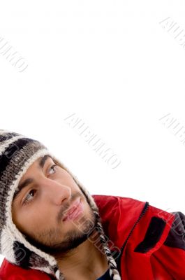 smart young guy in winter cap looking sideways