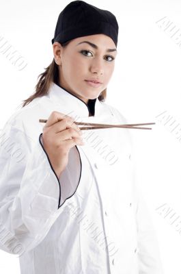 professional female chef holding chopstick