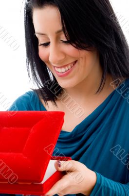 side pose of woman looking in jewellery box