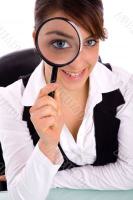 smiling young woman holding magnifier