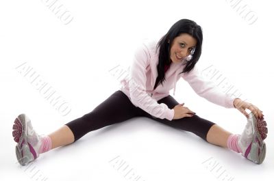 side view of smiling woman stretching her legs