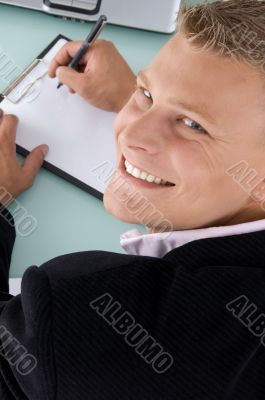smiling employee with pen and writing board
