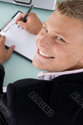 smiling employee with pen and writing board smiling employee with pen and writing board