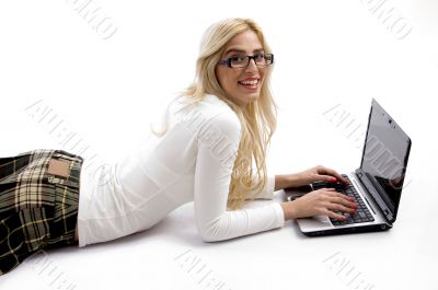 female lying down on floor and working on laptop female lying down on floor and working on laptop