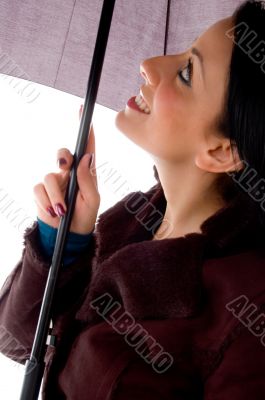 side view of smiling woman looking umbrella