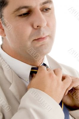 professional man adjusting his tie