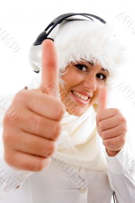  woman listening to music and showing thumbs up
