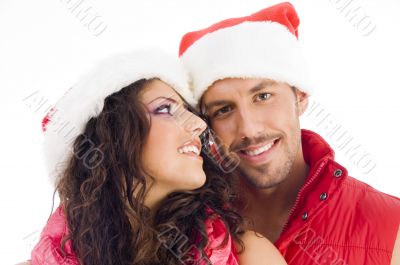 cheerful young couple wearing christmas hat