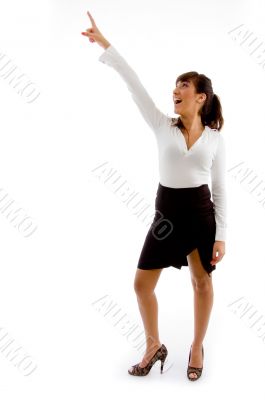 front view of smiling businesswoman pointing up