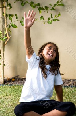 young boy raising his arms