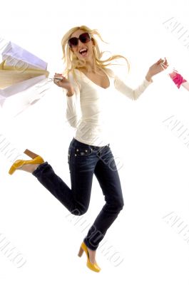 side view of pleased female holding carry bags