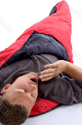 man in sleeping bag and yawning