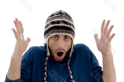 frightened young man wearing woolen cap