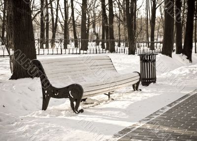 Single bench in winter city park