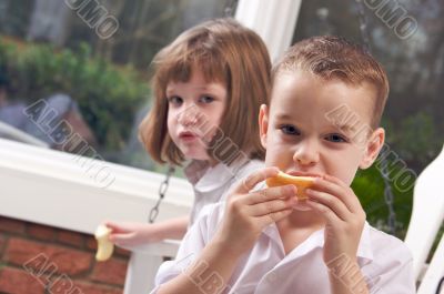 Sister and Brother Eating an Apple