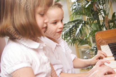 Children Playing the Piano