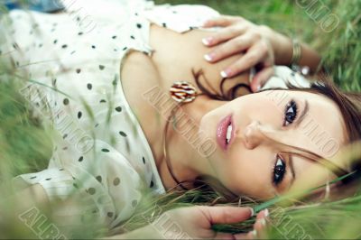 girl lying down of grass