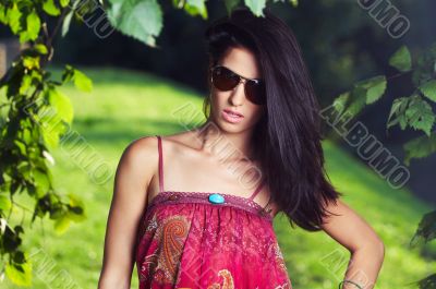 beautiful girl on grass in beautiful and colourful dress