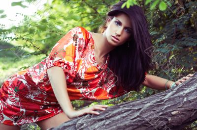 beautiful girl on grass in beautiful and colourful dress