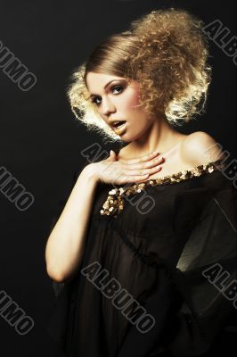 fashion model with curly hair in black tunic